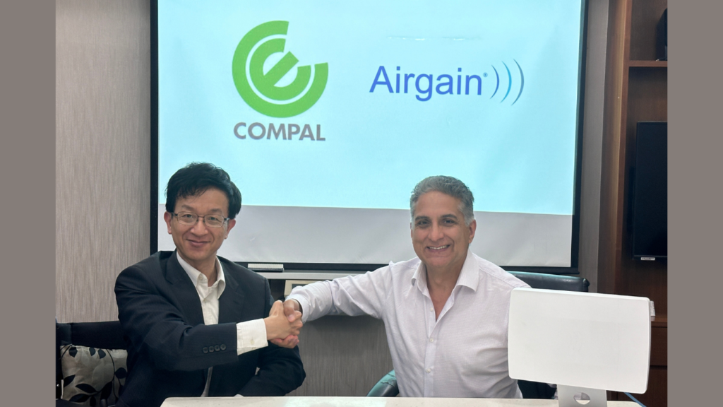 Yiyun Chang, Vice President at Compal Electronics, Inc. (left), shaking hands with Dr. Ali Sadri, CTO of Airgain, Inc., after signing a strategic MOU.