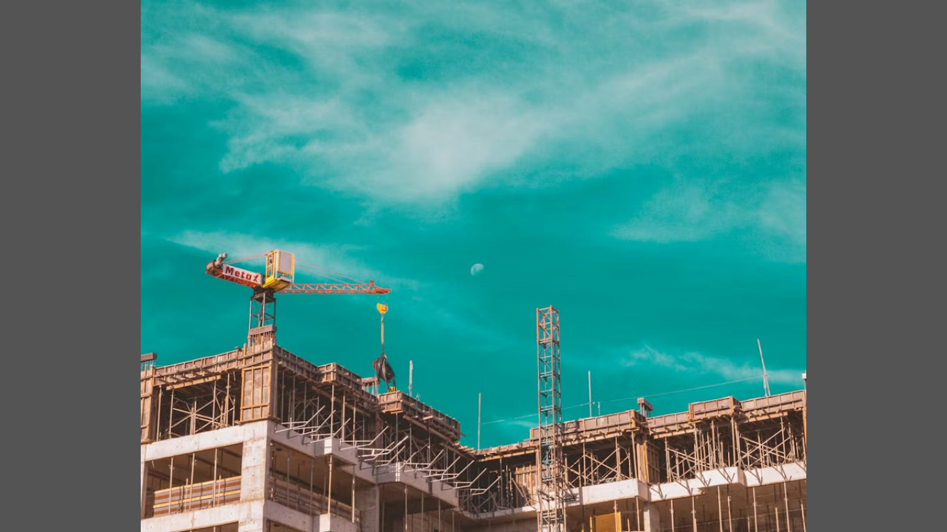 The Benefits of Using Eco-Friendly Building Materials (Image source: https://unsplash.com/photos/a-crane-on-top-of-a-building-under-construction-2m69lmXreFU)
