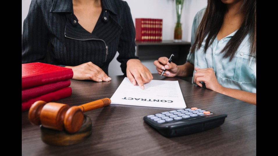 Black-woman-pointing-document-near-lady-with-pen-table-with-calculator-gavel (Image credit: Freepik)