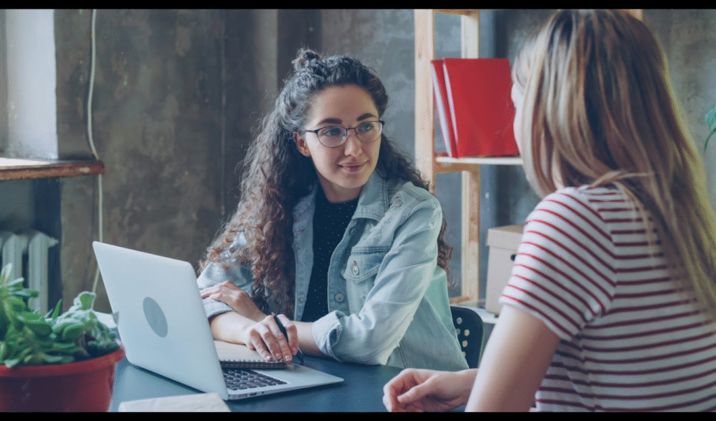 6 Interface Problems That Are Quietly Costing Your Startup Growth. (https://unsplash.com/photos/two-women-are-having-a-conversation-at-a-desk-Q2lxBgJ0eY0)