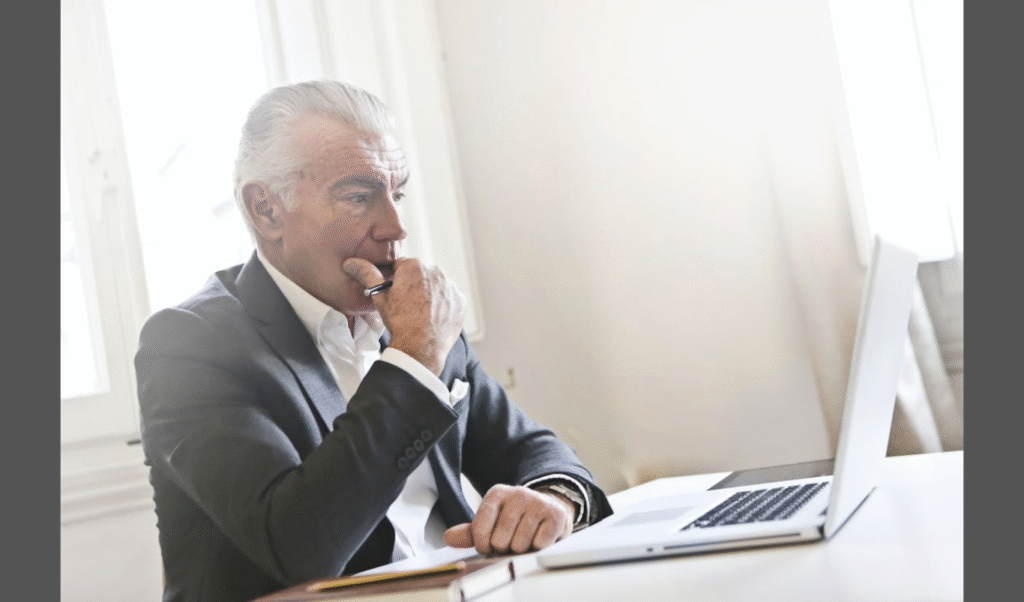 How US Employers Avoid W-2 Penalties in 2026 (Image source: https://www.pexels.com/photo/pensive-man-leaning-on-white-table-3782216/)