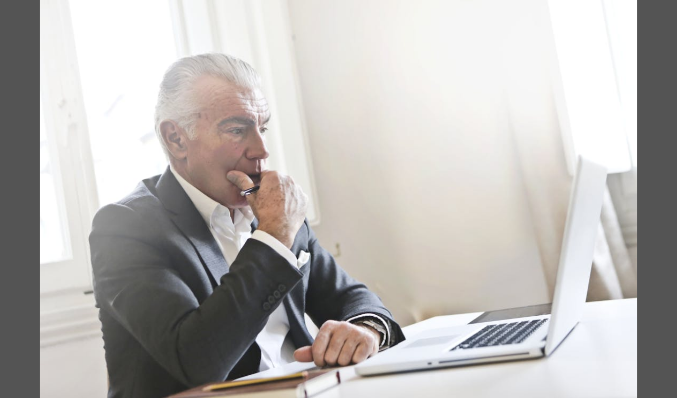 How US Employers Avoid W-2 Penalties in 2026 (Image source: https://www.pexels.com/photo/pensive-man-leaning-on-white-table-3782216/)