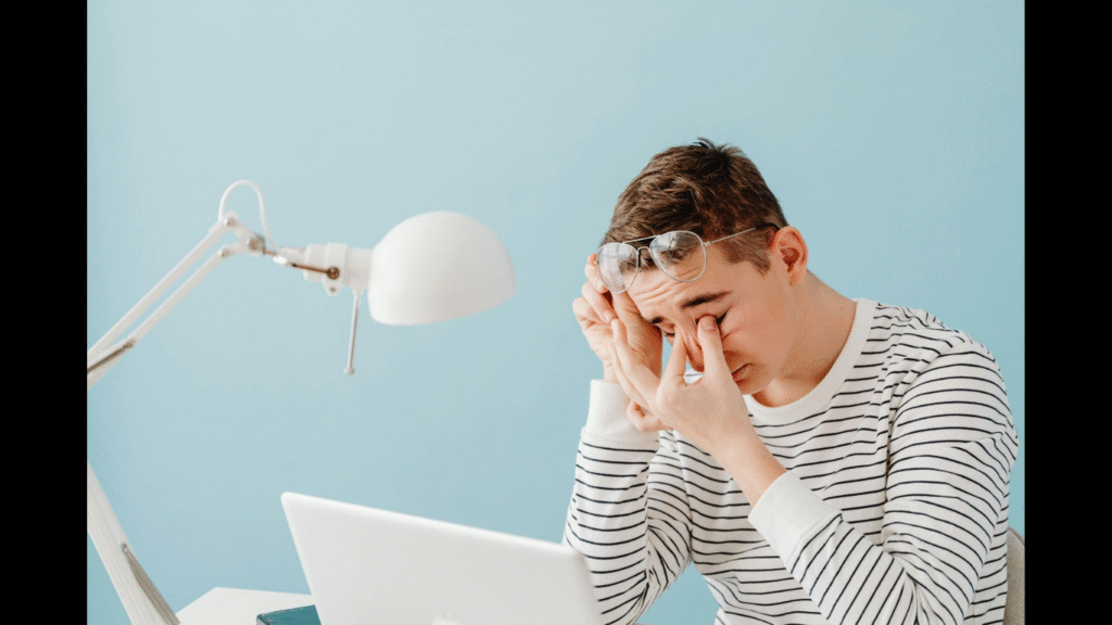 Why Digital Strain Lowers Employee Focus and Performance. (Image Source: https://www.pexels.com/photo/tired-man-with-laptop-6345335/)
