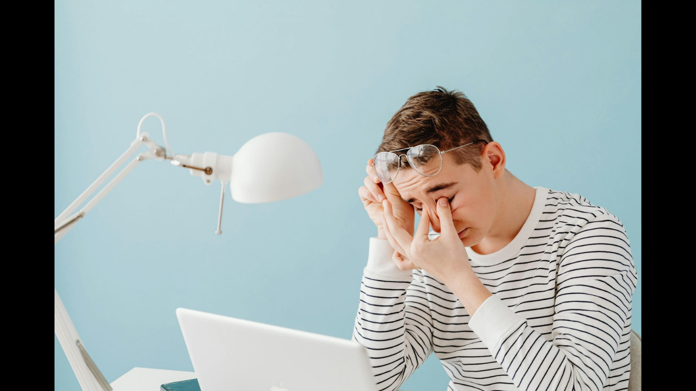Why Digital Strain Lowers Employee Focus and Performance. (Image Source: https://www.pexels.com/photo/tired-man-with-laptop-6345335/)
