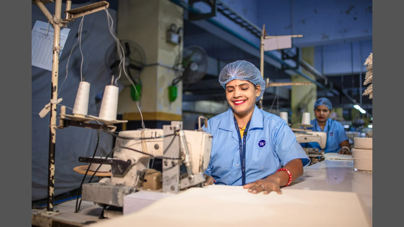 Why Employee Safety Protocols Prevent Costly Lawsuits. (IMAGE SOURCE: https://www.pexels.com/photo/smiling-female-factory-workers-operating-sewing-machines-31030910/)