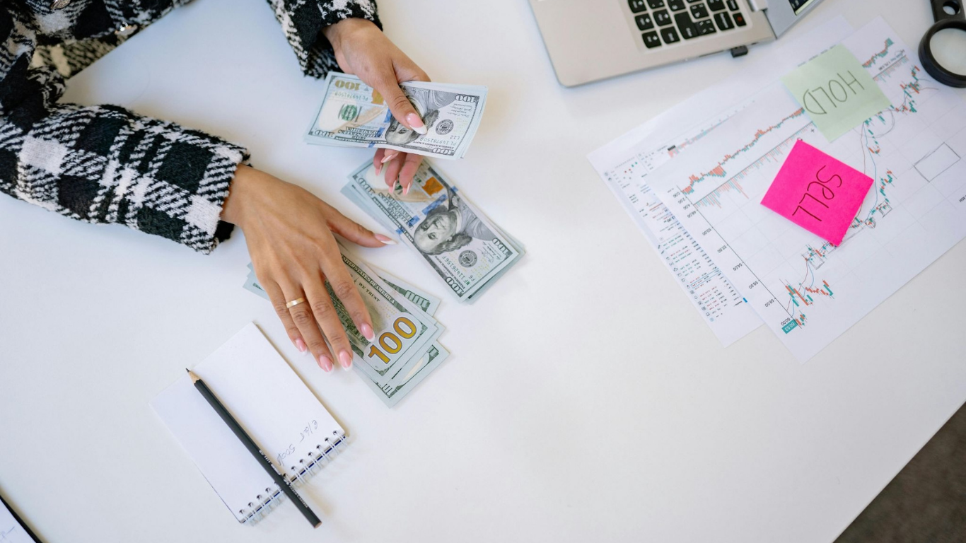How Specialized Financial Services Improve Manufacturing Operations. (Image Source: https://www.pexels.com/photo/a-person-counting-money-7691664/)